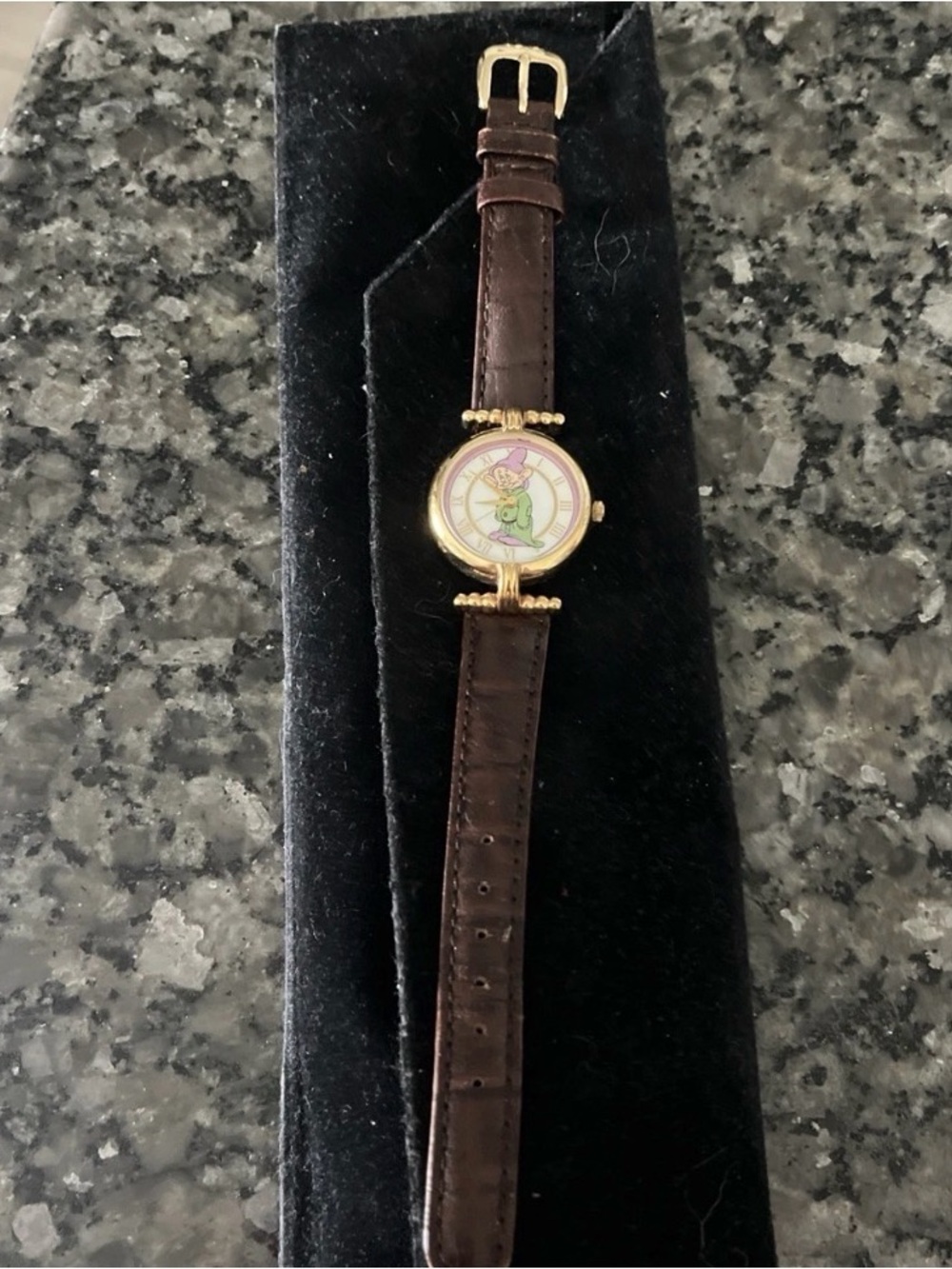 Gold Tone Round Watch with Brown Leather Strap and Playful Character Dial